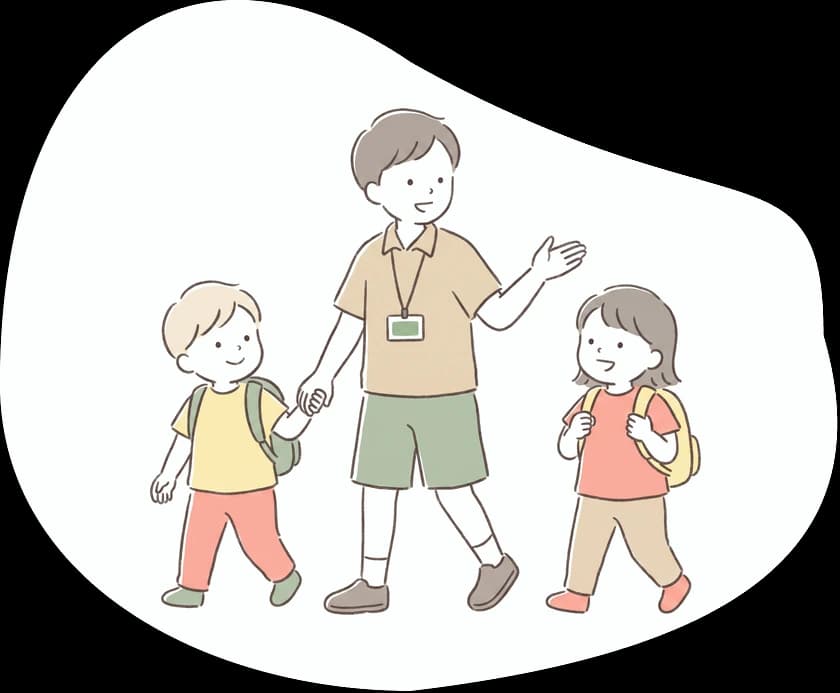 子どもと手をつないで案内する引率スタッフ